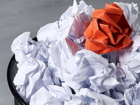 Concept. Creased paper in a trash can